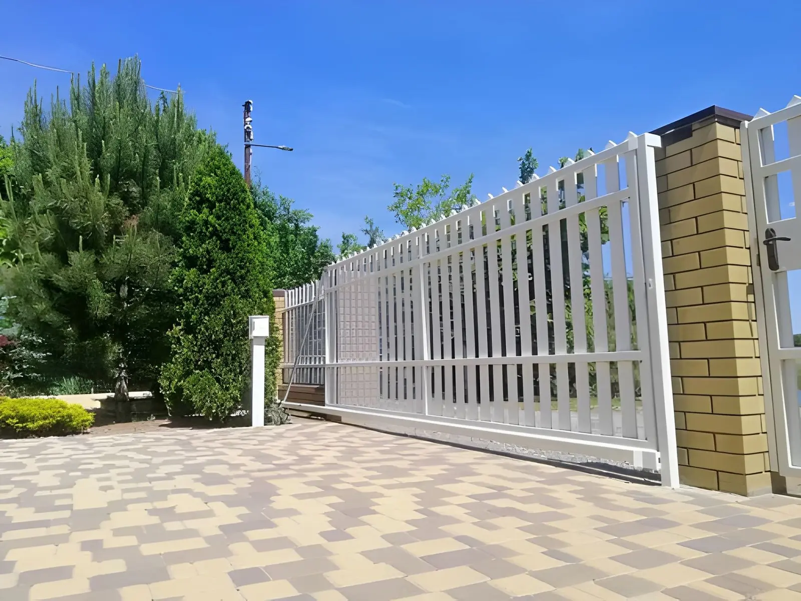 Fence Contractor in Los Altos Hills installing automated driveway gate system for large estate home security