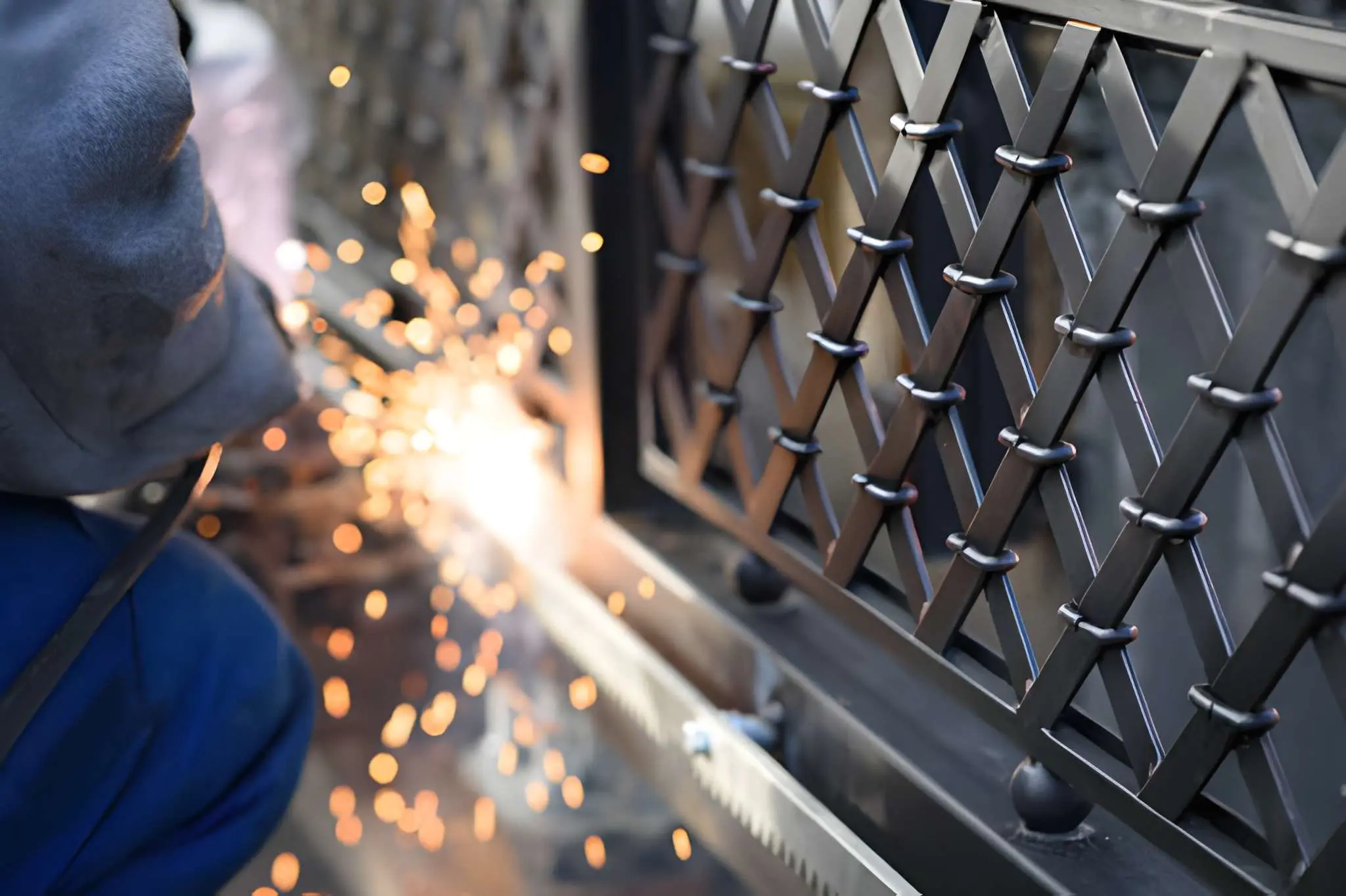 Electric Gate Repair technician inspecting motor system for faults